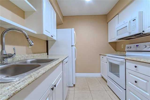 a kitchen with a sink and a stove top oven