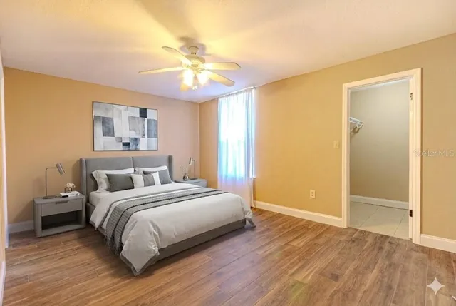 a bedroom with a large bed and a chandelier
