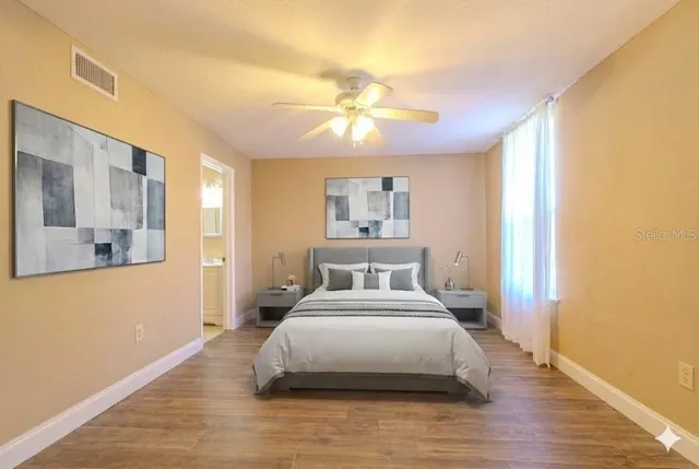 a bedroom with a bed and a chandelier