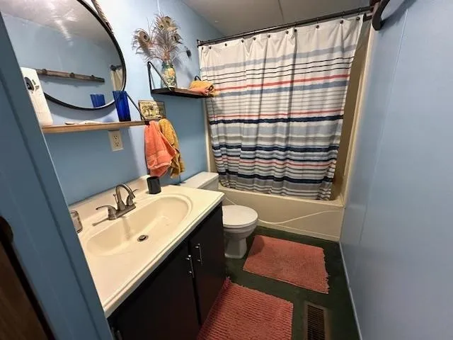 a bathroom with a sink toilet and mirror