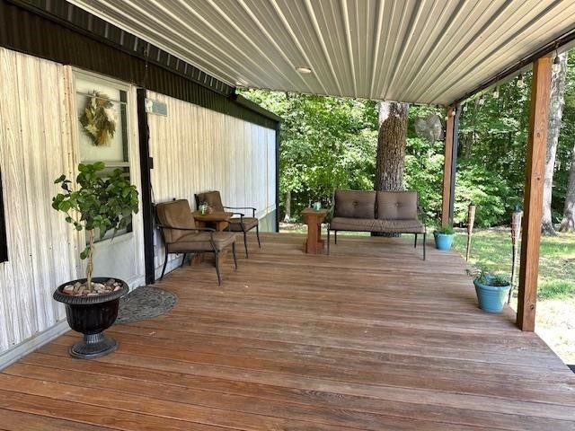484 Stokes Lane Bath Springs, TN 38311 - Photo 4 of 40 a living room with patio furniture and a potted plant