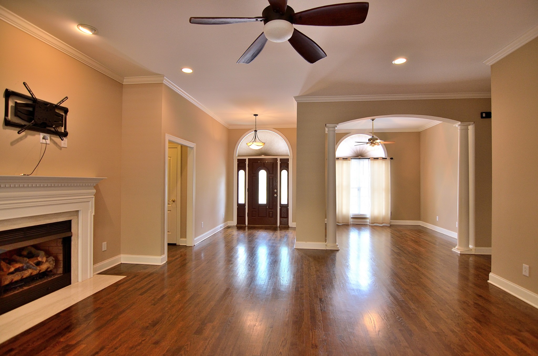 2600 Derby Run Road Springfield, TN 37172 - Photo 15 of 57 a view of a room with wooden floor a ceiling fan and a fireplace