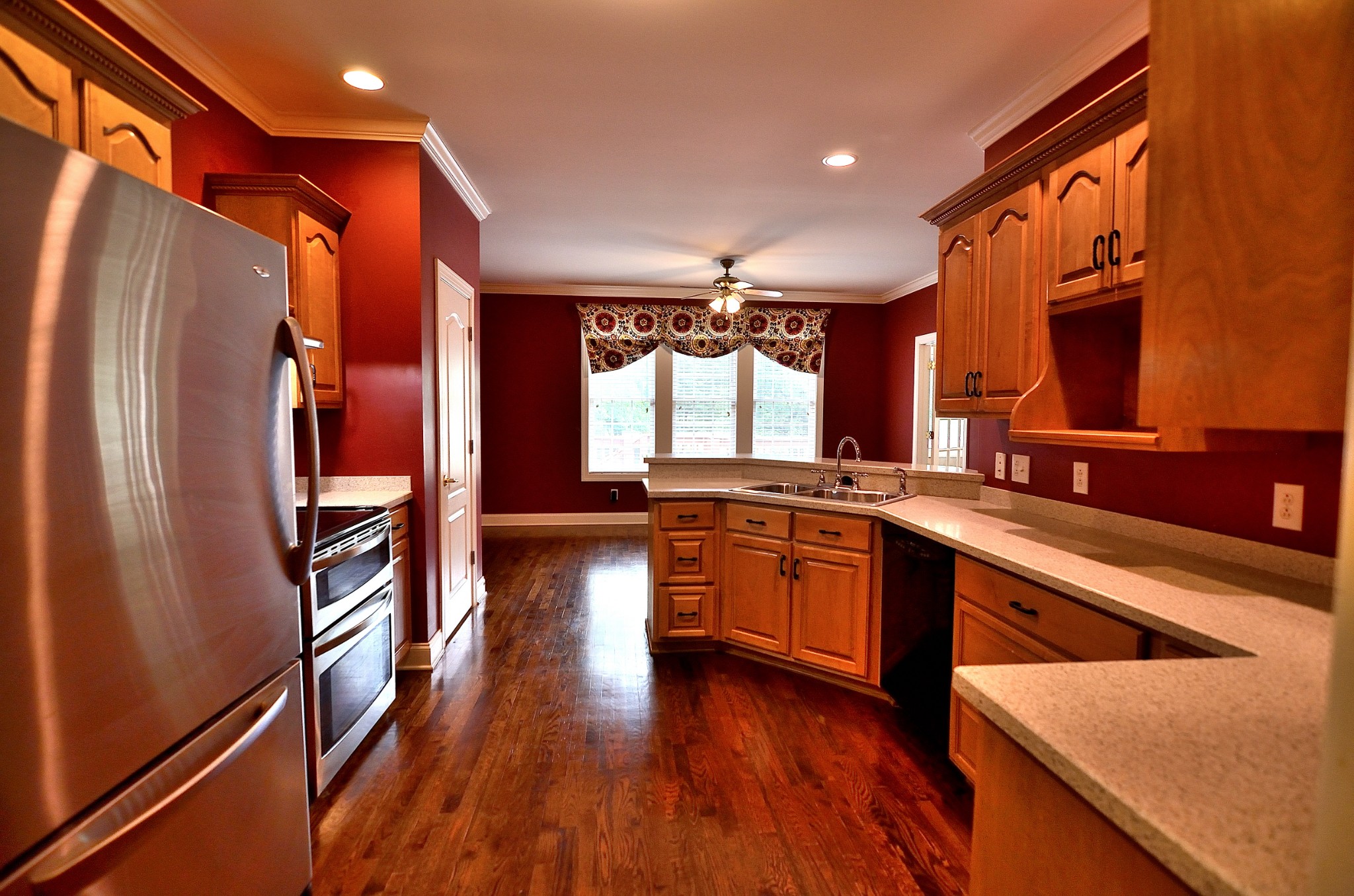 2600 Derby Run Road Springfield, TN 37172 - Photo 29 of 57 a large kitchen with stainless steel appliances granite countertop a refrigerator a sink dishwasher a stove and a dining table with wooden floor