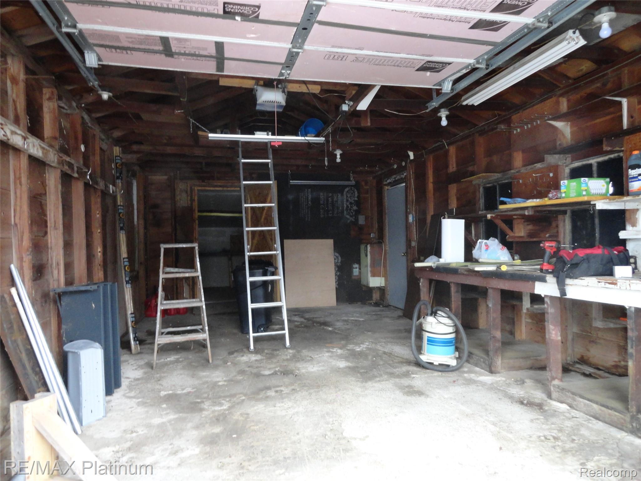 3396 East Baldwin Road Grand Blanc, MI 48439 - Photo 13 of 16 Garage featuring a garage door opener