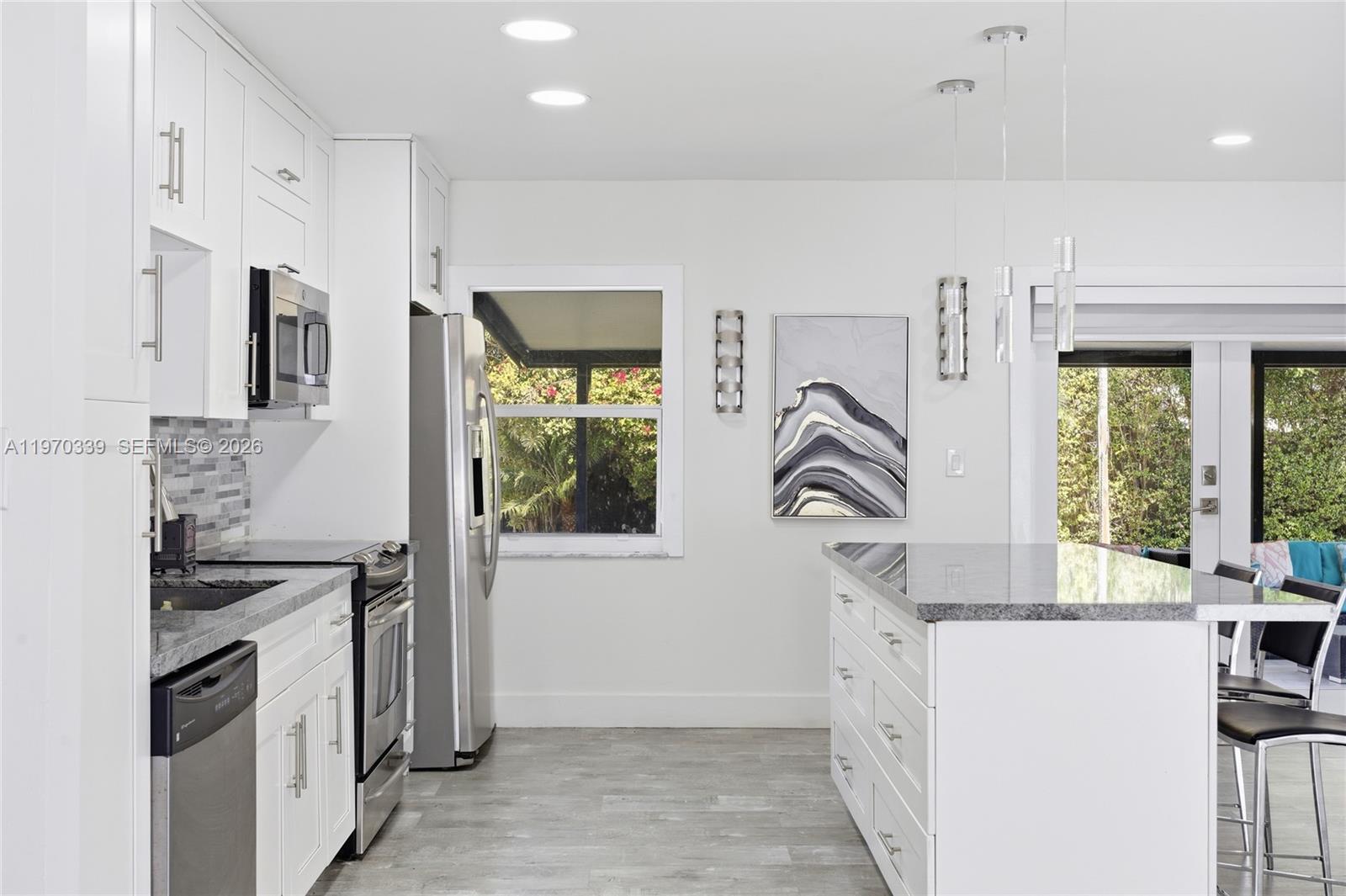12845 Southwest 72nd Terrace Miami, FL 33183 - Photo 17 of 33 a kitchen with white cabinets and a stove
