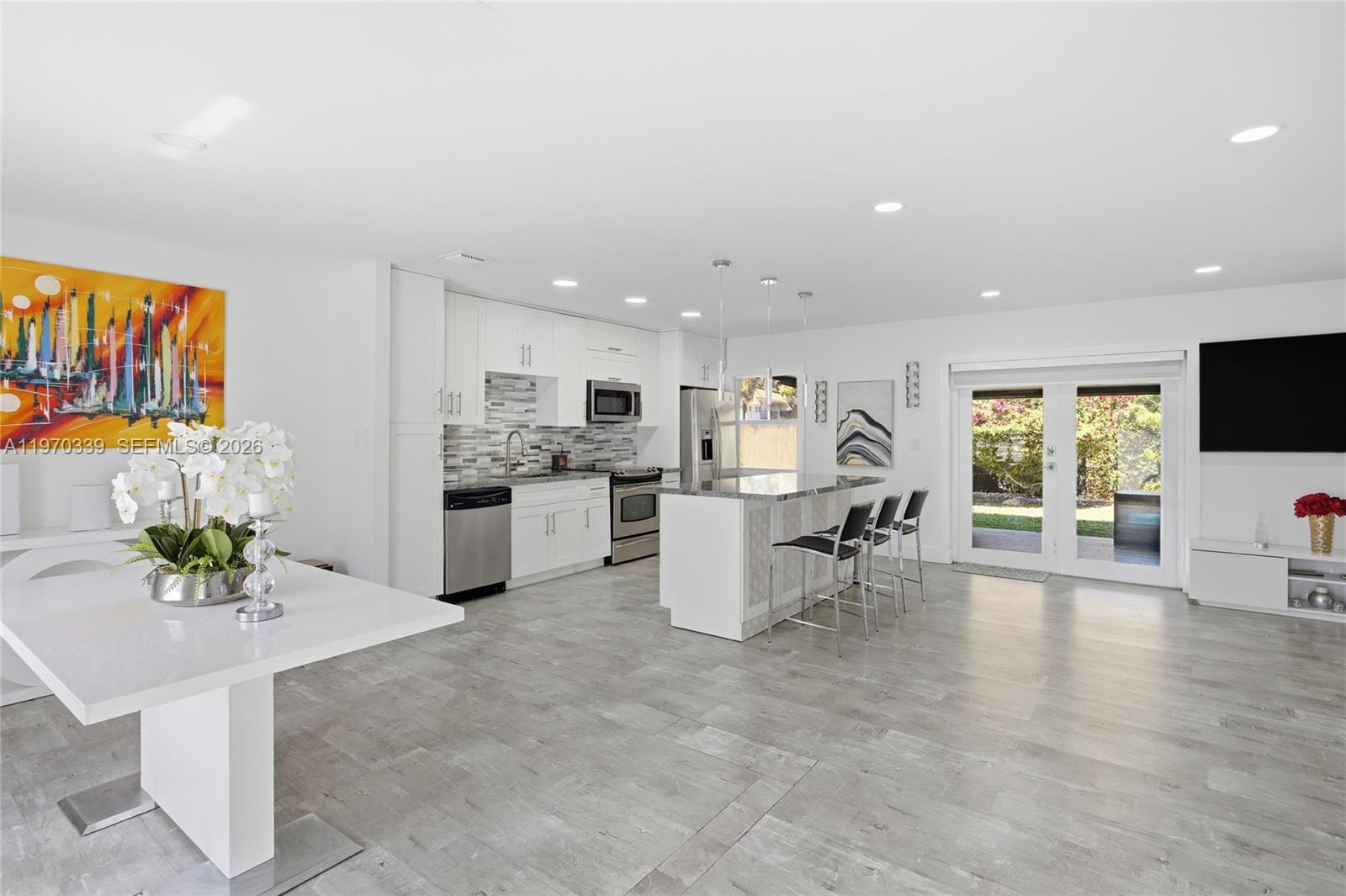 12845 Southwest 72nd Terrace Miami, FL 33183 - Photo 10 of 33 a living room with furniture and a kitchen area with fireplace