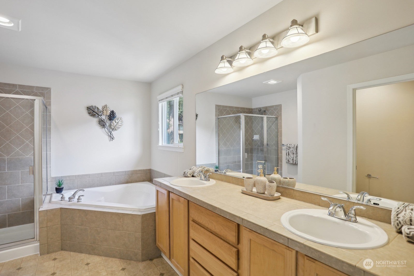 22712 30th Court Southeast Bothell, WA 98021 - Photo 24 of 38 a bathroom with a granite countertop double vanity sink a bathtub a mirror and vanity