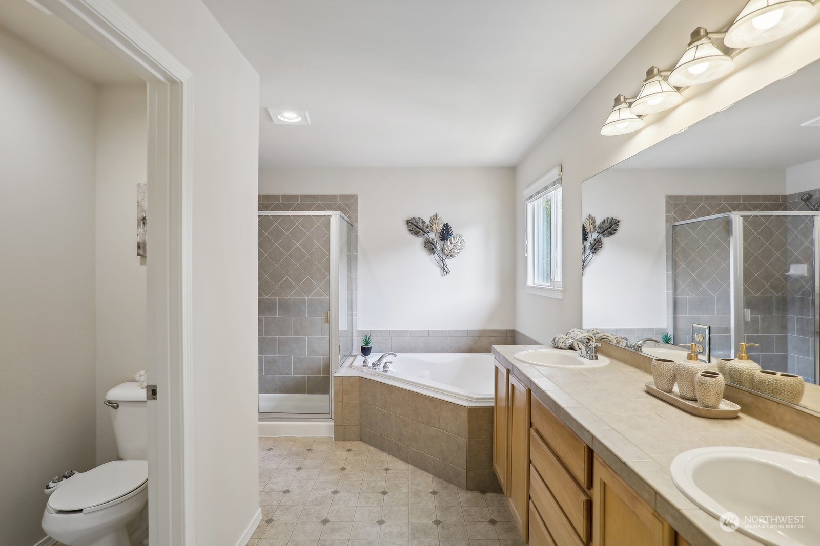 22712 30th Court Southeast Bothell, WA 98021 - Photo 25 of 38 a bathroom with a double vanity sink toilet mirror and bathtub