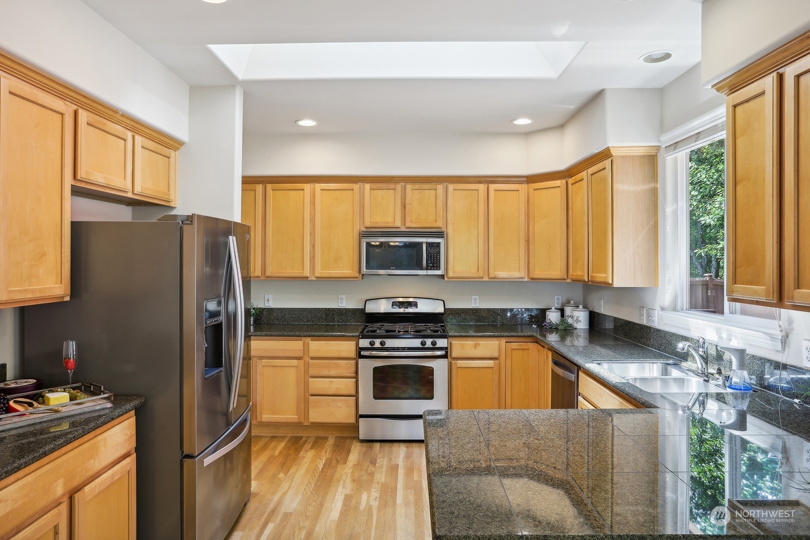 22712 30th Court Southeast Bothell, WA 98021 - Photo 8 of 38 a kitchen with a stove a sink and a refrigerator