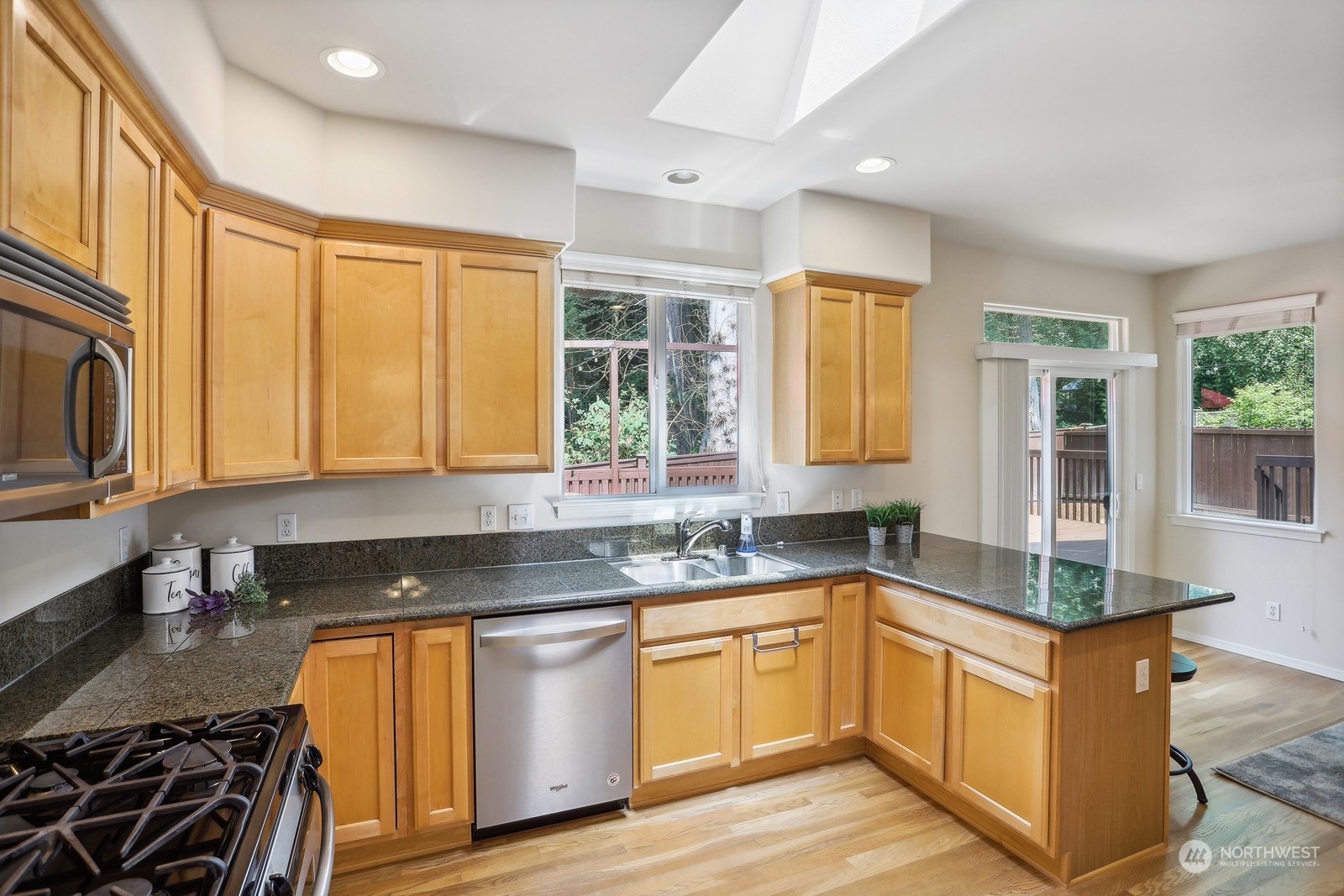 22712 30th Court Southeast Bothell, WA 98021 - Photo 9 of 38 a kitchen with granite countertop a sink stove and cabinets