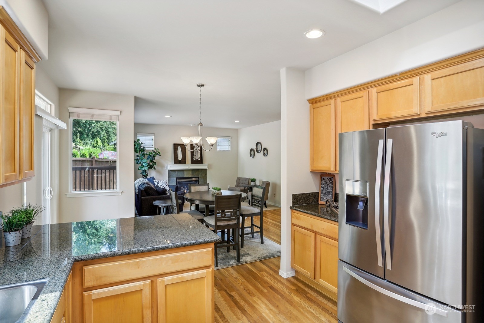 22712 30th Court Southeast Bothell, WA 98021 - Photo 10 of 38 a kitchen with stainless steel appliances granite countertop a refrigerator stove oven dining table and chairs