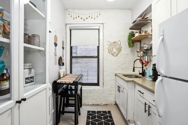 a view of kitchen with furniture and wooden floor