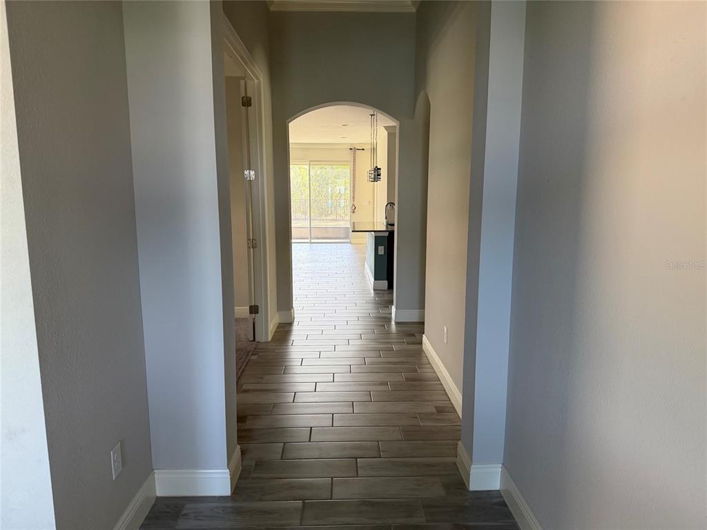 6204 Colmar Place Apollo Beach, FL 33572 - Photo 14 of 57 a view of a hallway with wooden floor