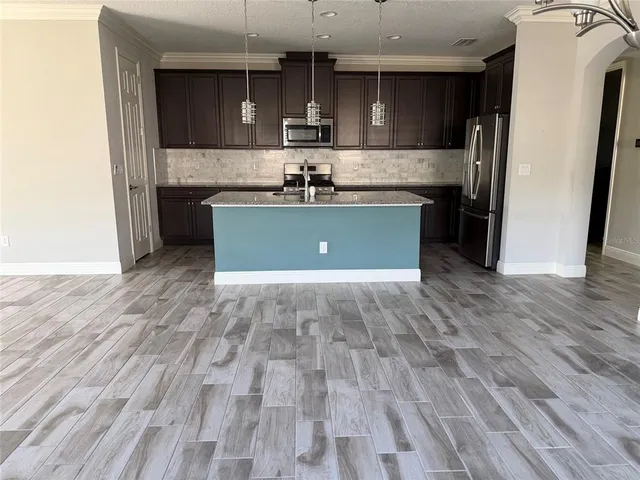 a view of kitchen with cabinets and stainless steel appliances