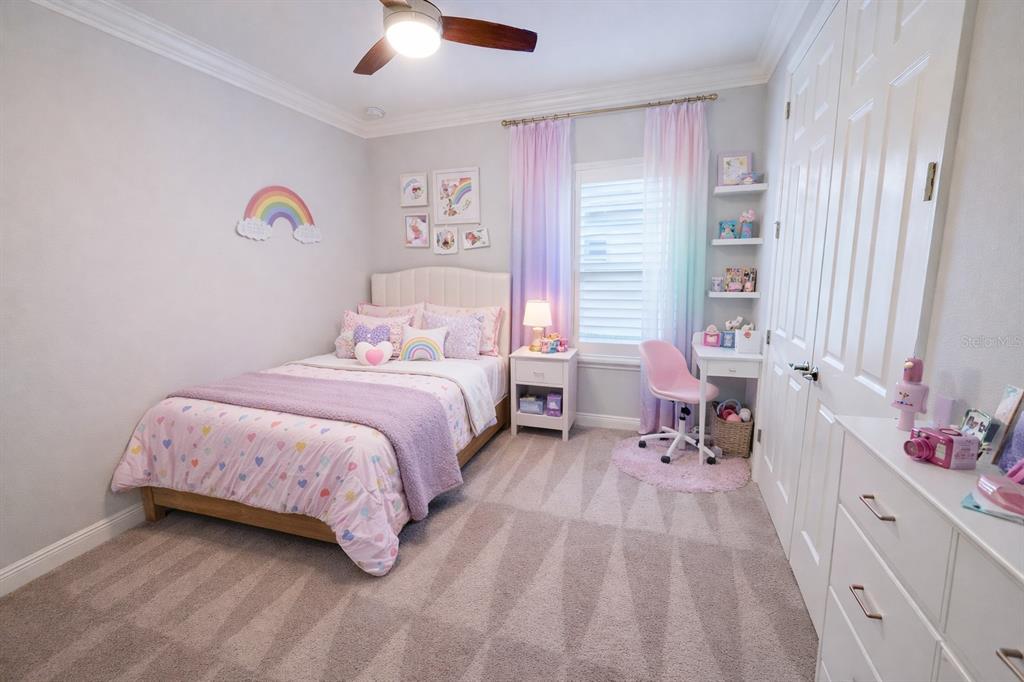 6204 Colmar Place Apollo Beach, FL 33572 - Photo 24 of 57 a bedroom with a bed and a chandelier