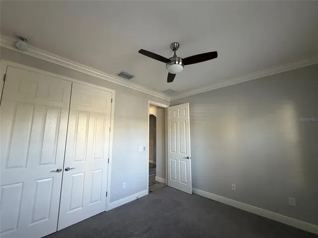 an empty room with closet and wooden floor