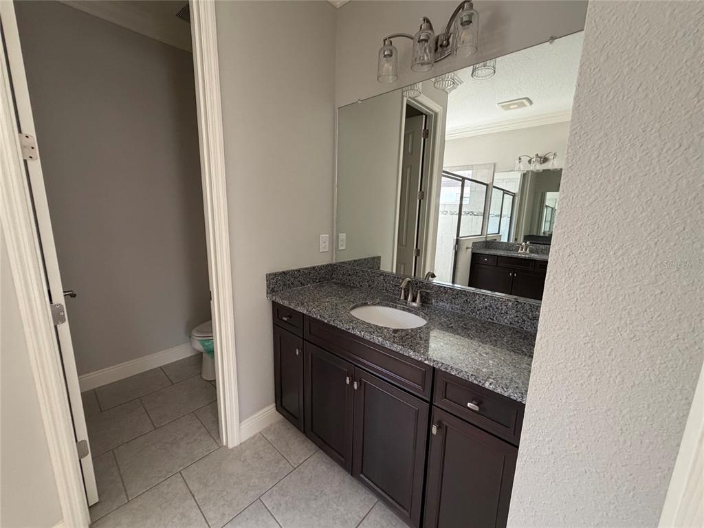 6204 Colmar Place Apollo Beach, FL 33572 - Photo 28 of 57 a bathroom with a granite countertop sink and a mirror