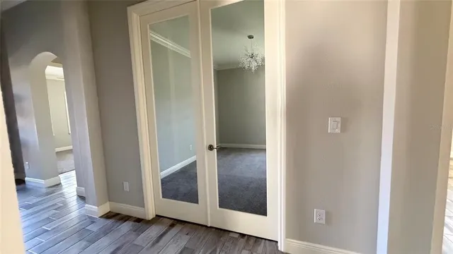 a view of a hallway with wooden floor