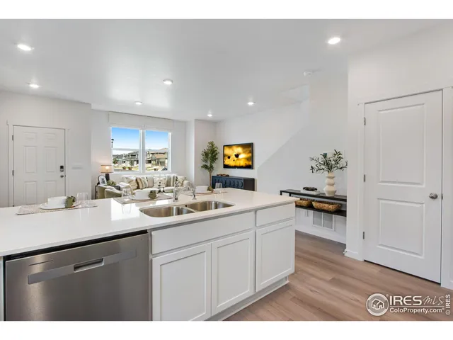 a kitchen with a sink and a refrigerator