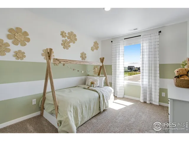 a bedroom with a bed and a painting on the wall
