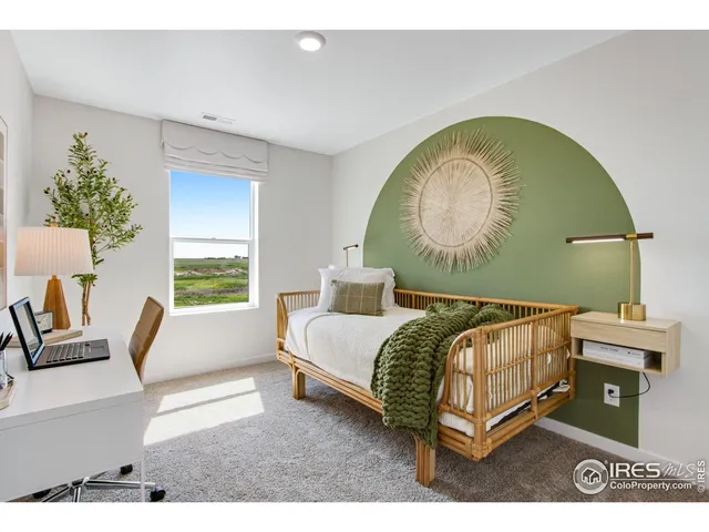 a bedroom with a bed and a painting on the wall