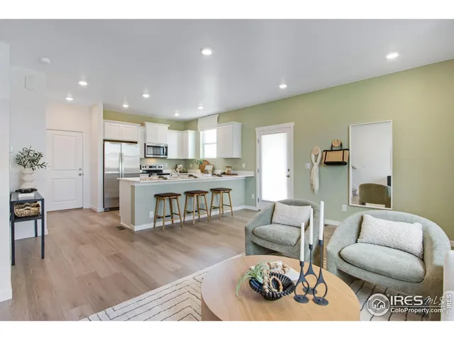 a living room with furniture and kitchen view