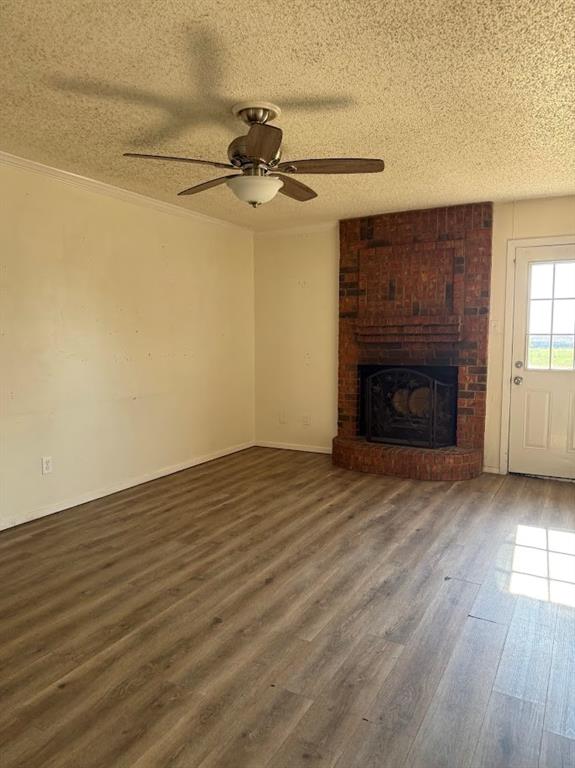11204 Liberty School Road Pelican Bay, TX 76020 - Photo 10 of 23 an empty room with wooden floor a fireplace and windows