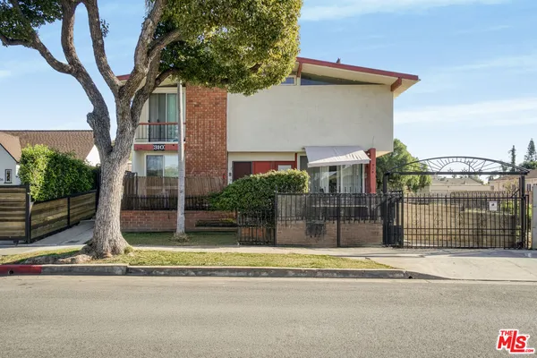 a view of a house with a iron fence