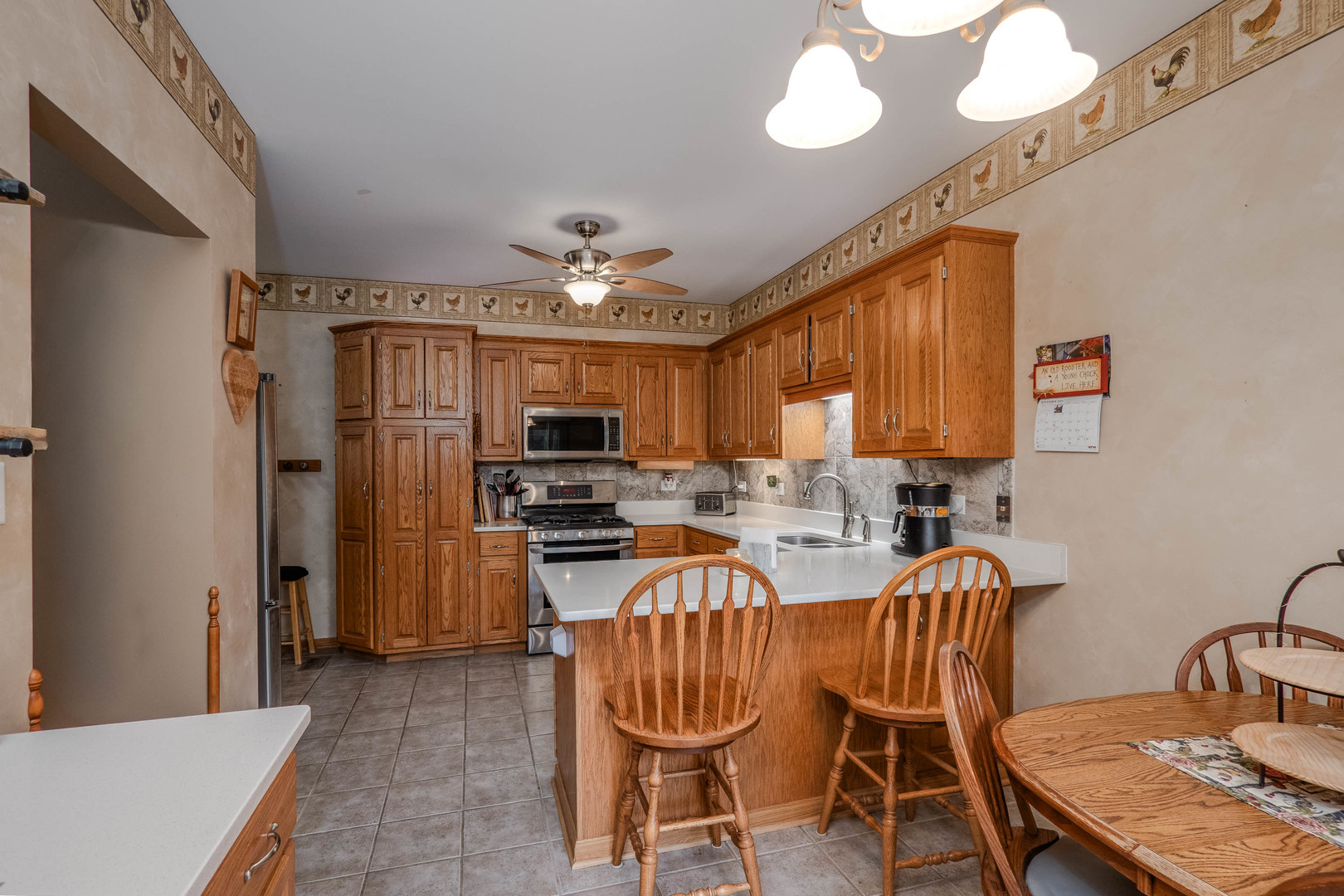 18808 Foxglove Lane Mokena, IL 60448 - Photo 15 of 26 a view of a dining room with furniture a chandelier and wooden floor