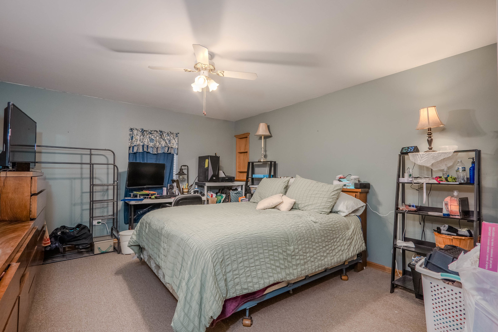 18808 Foxglove Lane Mokena, IL 60448 - Photo 10 of 26 a bedroom with a bed a flat screen tv and a chandelier