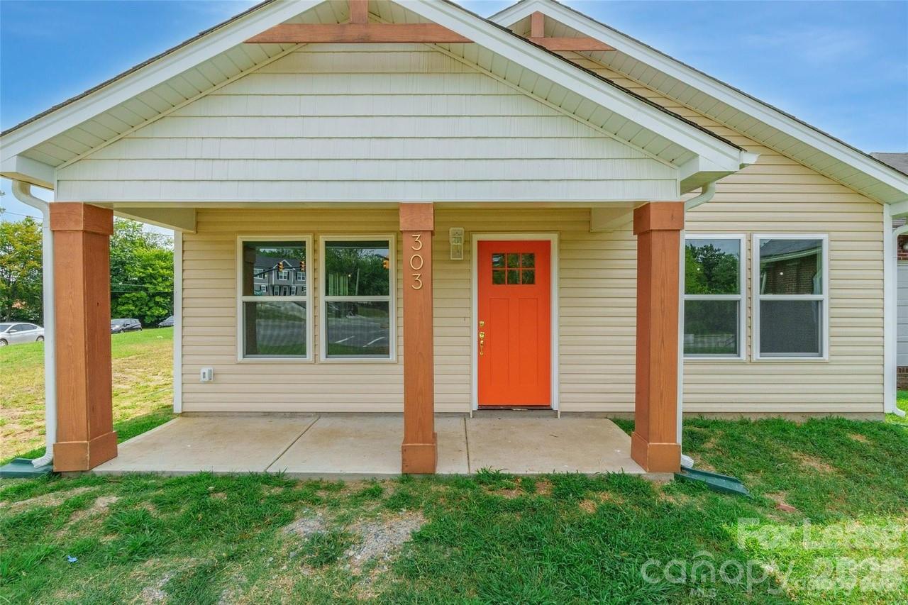 303 Cabarrus Avenue West Concord, NC 28025 - Photo 1 of 17 a front view of a house with a yard
