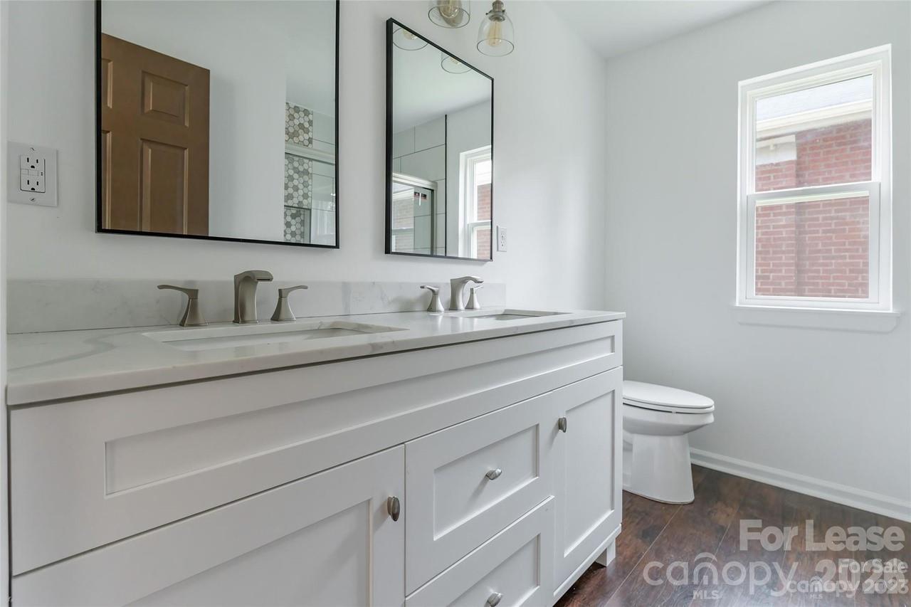 303 Cabarrus Avenue West Concord, NC 28025 - Photo 11 of 17 a bathroom with a toilet sink and mirror