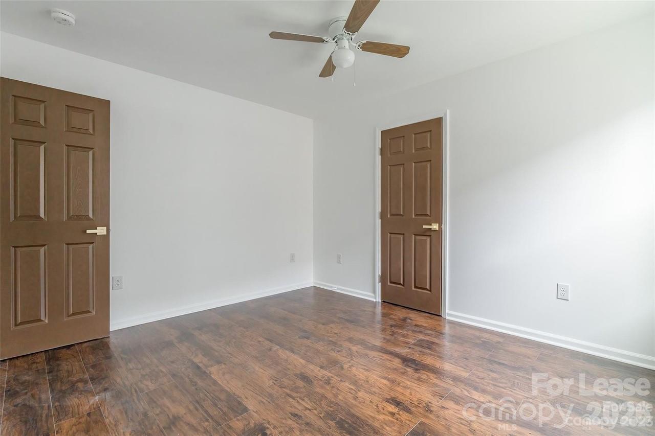 303 Cabarrus Avenue West Concord, NC 28025 - Photo 14 of 17 an empty room with wooden floor and closet area