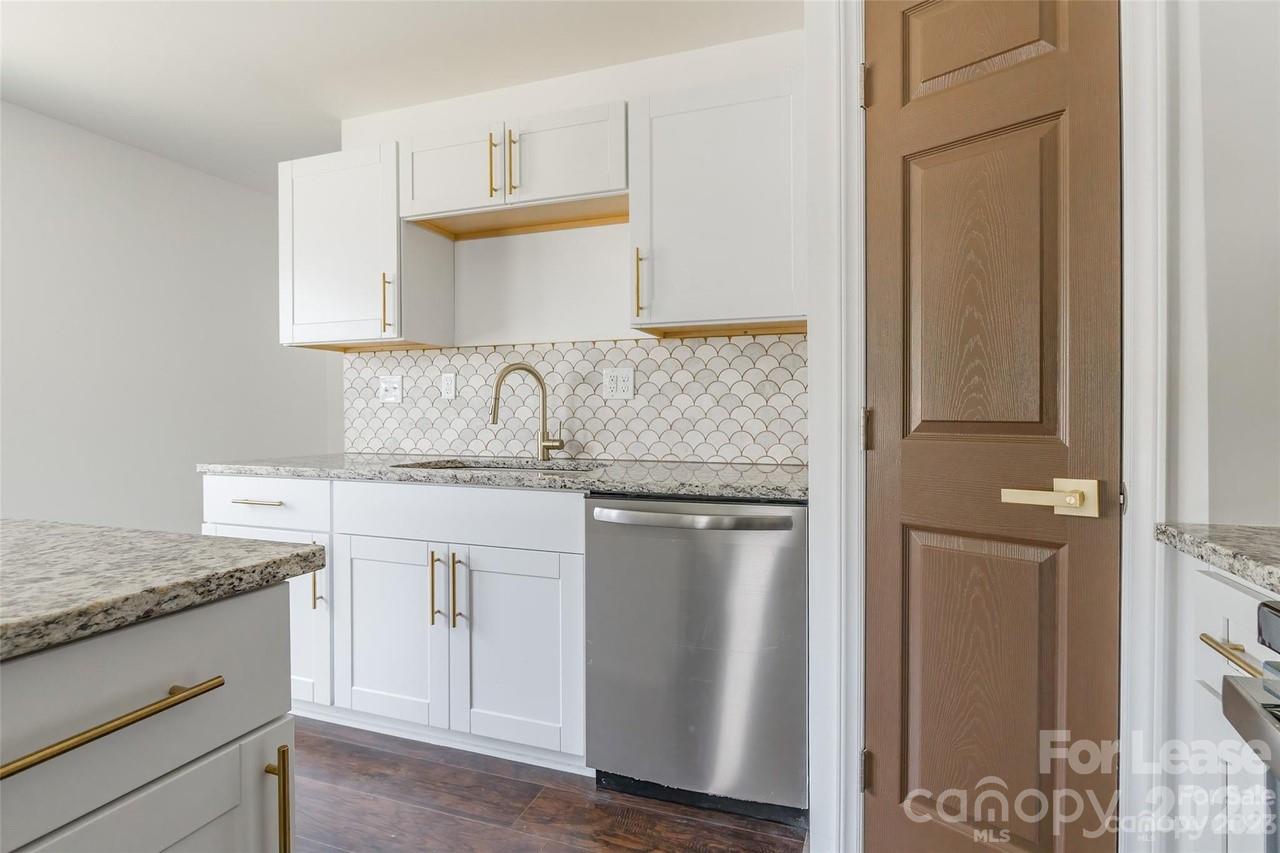 303 Cabarrus Avenue West Concord, NC 28025 - Photo 6 of 17 a kitchen with stainless steel appliances granite countertop a sink stove and refrigerator