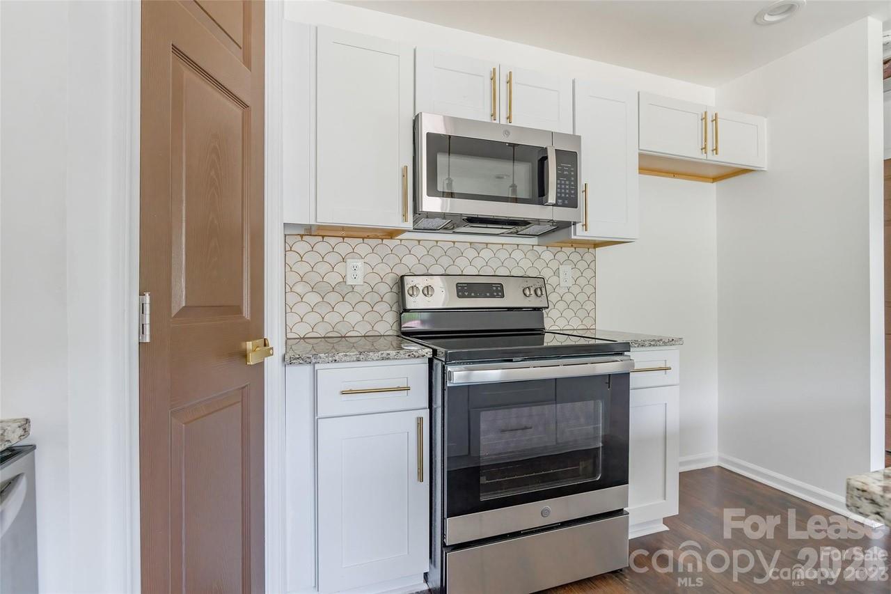 303 Cabarrus Avenue West Concord, NC 28025 - Photo 7 of 17 a kitchen with a stove and a microwave