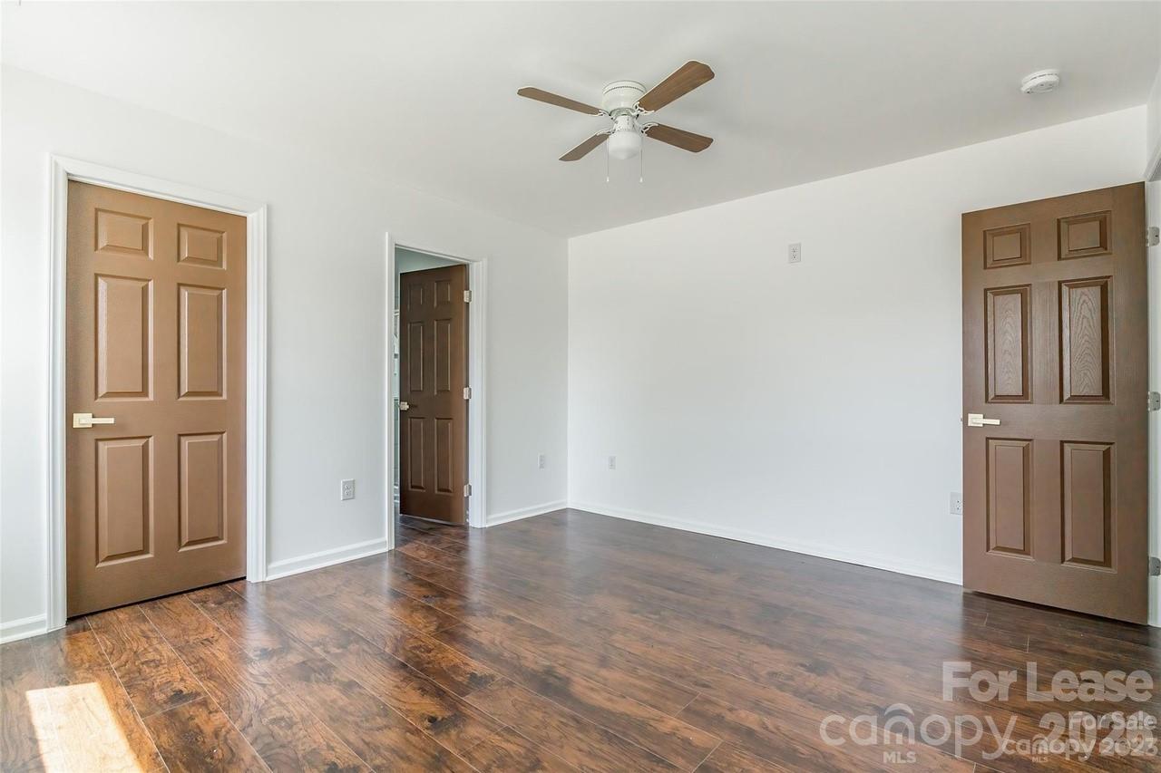 303 Cabarrus Avenue West Concord, NC 28025 - Photo 10 of 17 an empty room with wooden floor closet and windows
