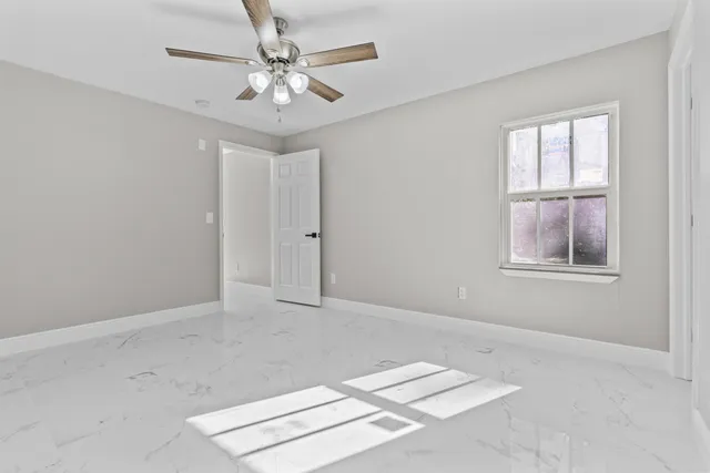 a view of an empty room with windows