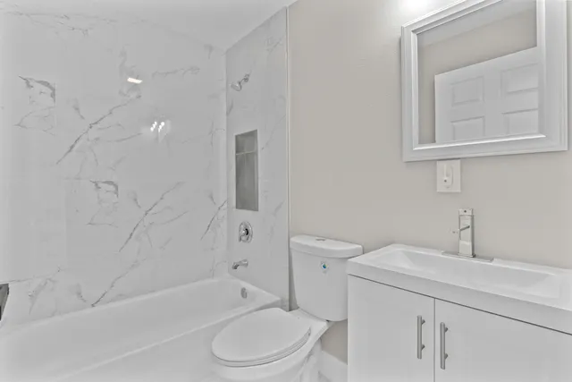 a bathroom with a sink a toilet and bathtub