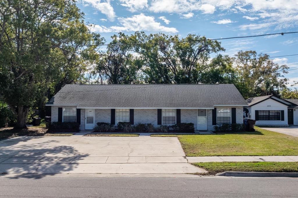 a view of house that has a tree in front of it