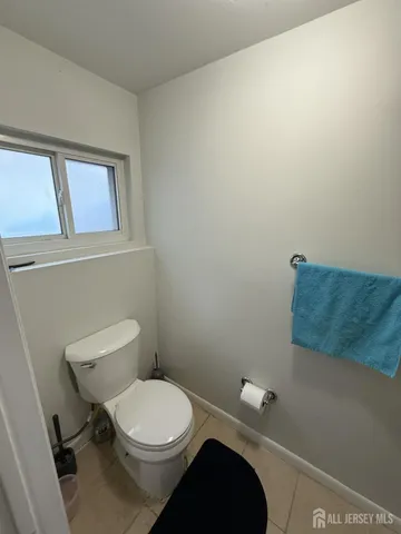 a white toilet sitting next to a bathroom sink and vanity