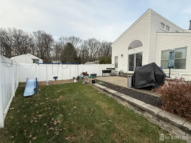 a view of a house with backyard and sitting area