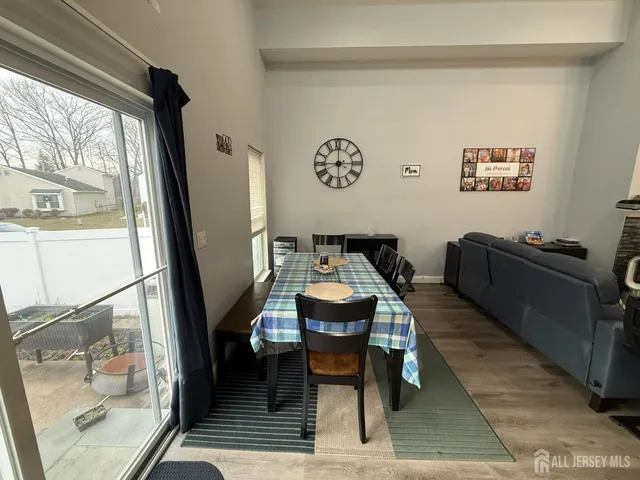 a dining room with furniture and a window