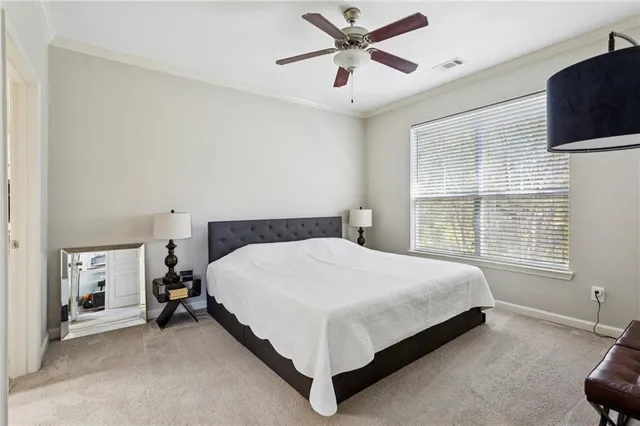 a large bed sitting in a bedroom next to a window