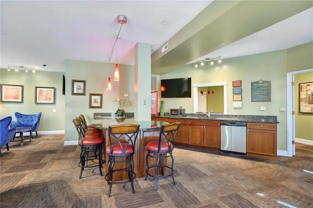 a large kitchen with a table and chairs
