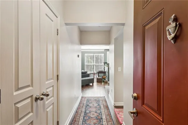 a view of a hallway with wooden floor and staircase