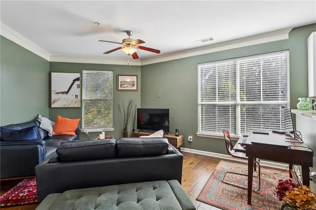 a living room with furniture and a floor to ceiling window
