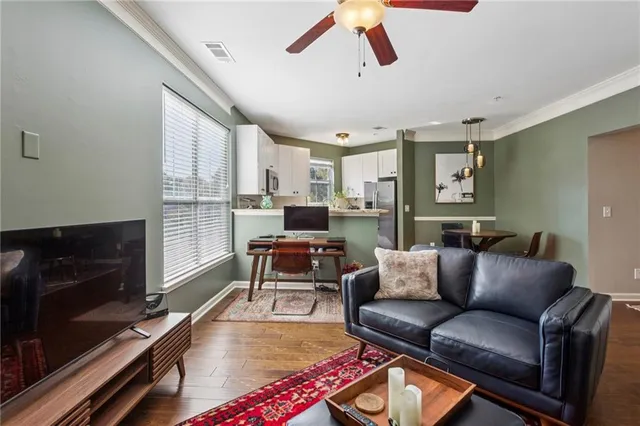 a living room with furniture a flat screen tv and a fireplace
