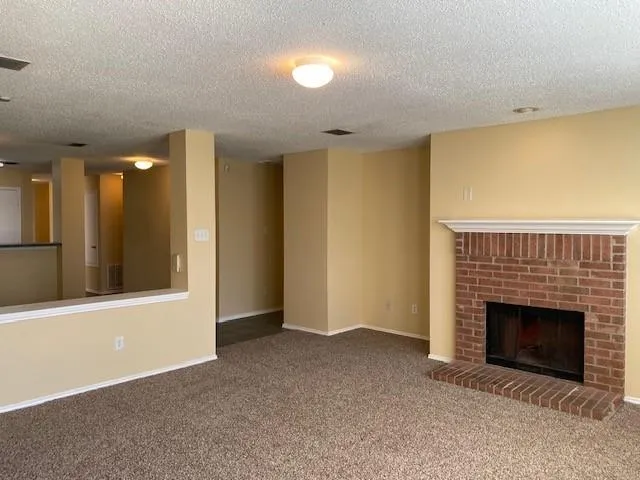 a view of an empty room with a fireplace