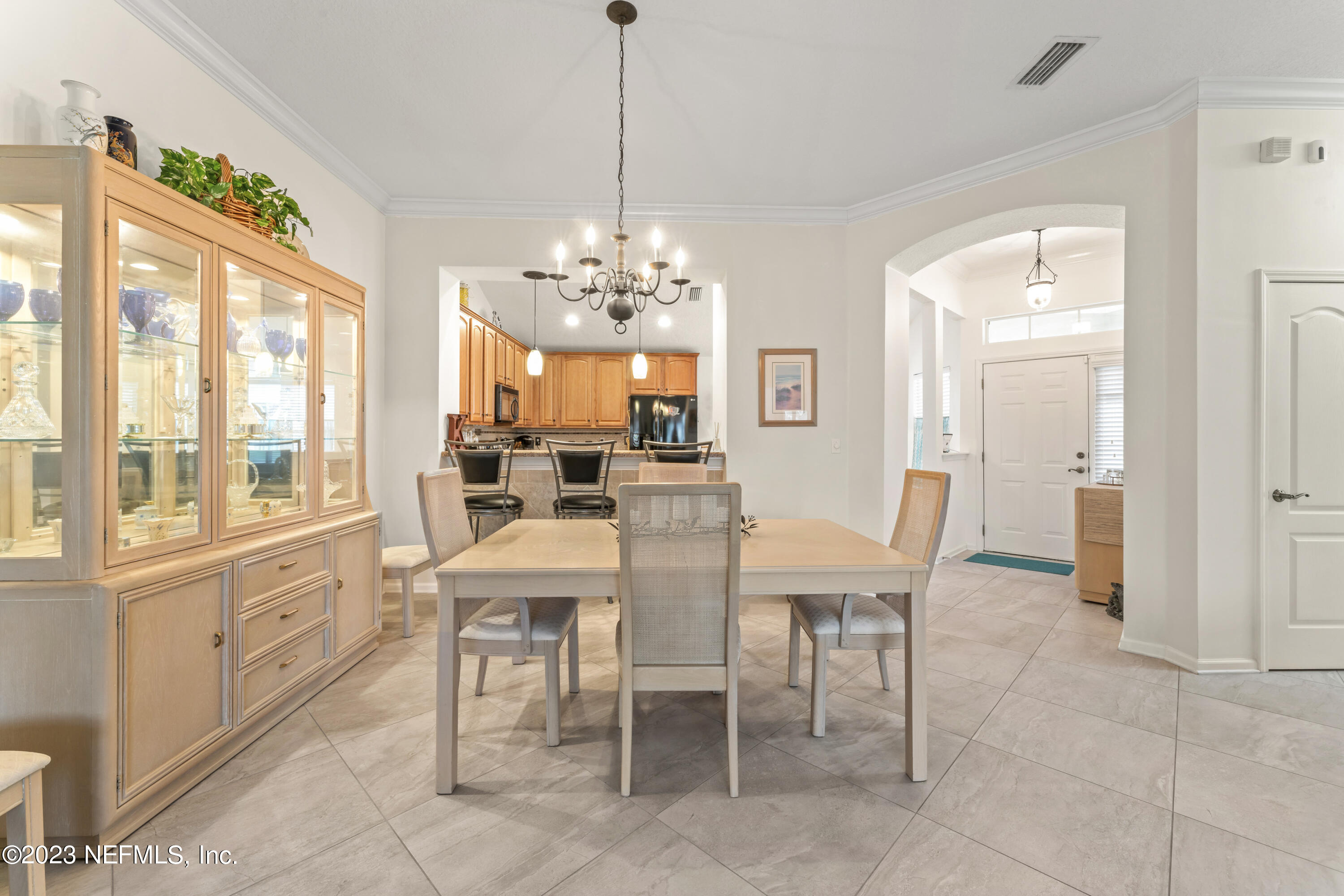 1840 Copper Stone Drive, Unit D Fleming Island, FL 32003 - Photo 15 of 66 a view of a dining room with furniture large windows a chandelier and a livingroom
