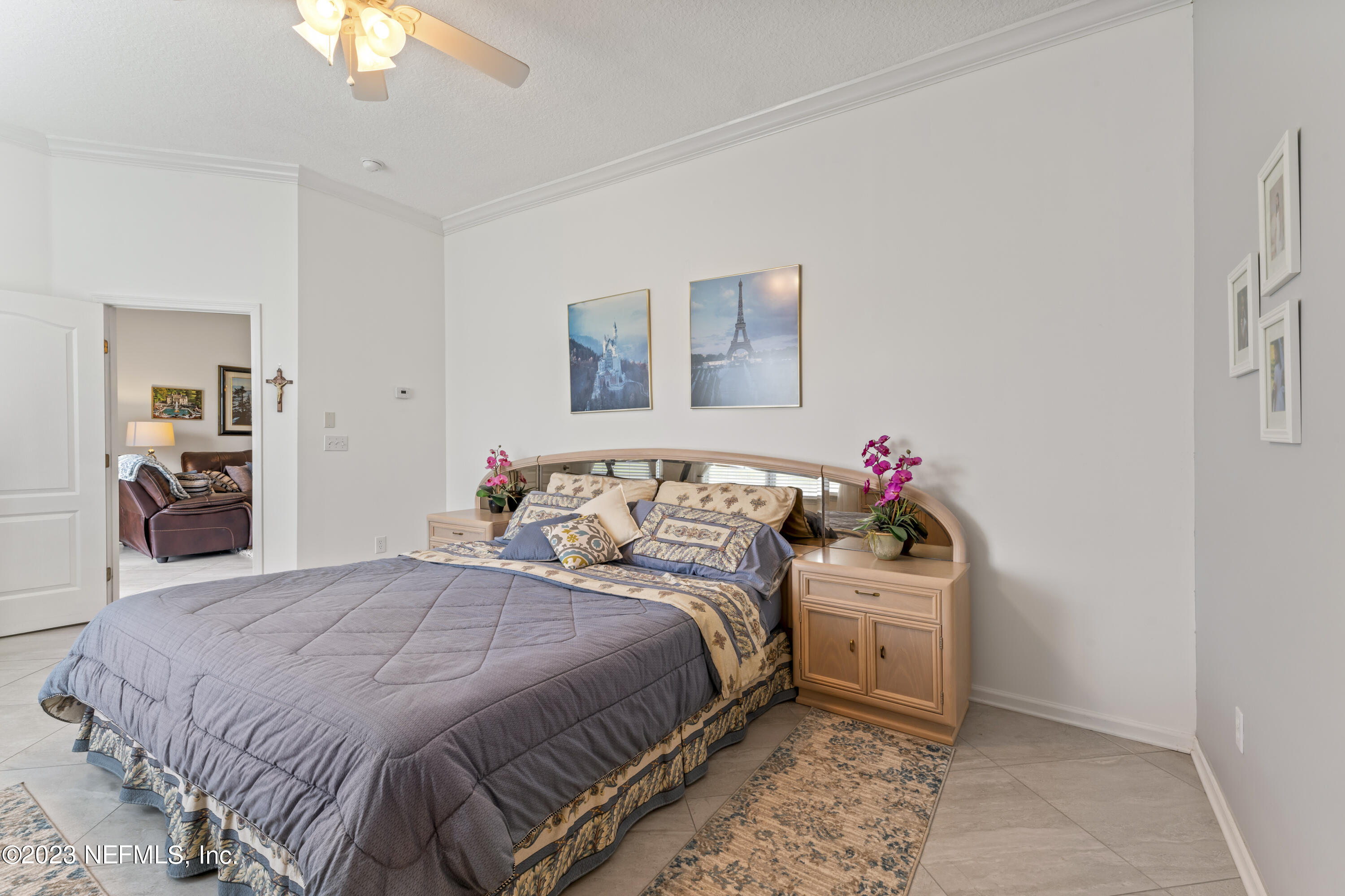 1840 Copper Stone Drive, Unit D Fleming Island, FL 32003 - Photo 18 of 66 a bedroom with a bed and a chandelier